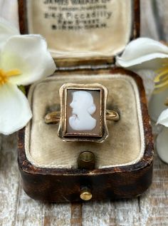 A lovely vintage cameo ring crafted in 9 carat solid yellow gold hallmarked in London in 1966.  This wonderful ring features a carved portrait of a lady set in a yellow gold bezel which provides a nice contrast and enhances the details of the carving.  The elegant rectangular shape of the cameo provides a timeless and sophisticated look leading to a sturdy plain polished shank.  It looks wonderful on the finger and has a nice solid heavy feel. In good vintage condition with light wear.  The came Vintage Carved Signet Ring For Formal Occasions, Antique Engraved Cabochon Ring, Antique Intaglio Signet Ring For Anniversary, Antique Signet Ring With Intaglio For Anniversary, Vintage Gold Ring For Memorial, Vintage Carved Rings For Formal Events, Vintage Carved Rings For Formal Occasions, Classic Cameo Rings, Vintage Cameo Engraved Ring For Formal Occasions