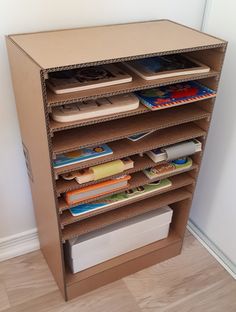 a cardboard book shelf with many books on it