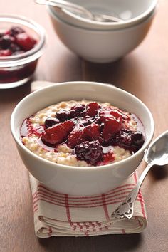 a bowl of oatmeal with berries in it