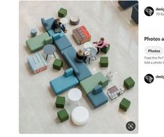 an overhead view of people sitting at tables and couches in a lobby with green and blue furniture