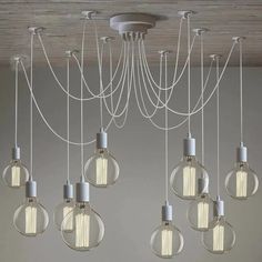 a chandelier with eight lights hanging from it's sides and several bulbs on the ceiling