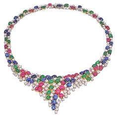 A spectacular necklace crafted in two tone gold, encrusted with 38 carats of gemstones: Rubies, Sapphires and Emeralds. Accented with round cut diamonds in between this is a fabolous necklace for someone who loves color and richness of the gems. A substantial necklace is in excellent condition and suits a neckline of about 15 inchs and drops to about 17 inches. All of the gemstones are of prestine color, diamonds are brilliant and white. Diamond Drop Pendant, Fine Necklace, Gold Drop Necklace, Yellow Necklace, Necklace Stone, Diamond Jewel, Drop Pendant Necklace, Necklace Craft, Silver Tops