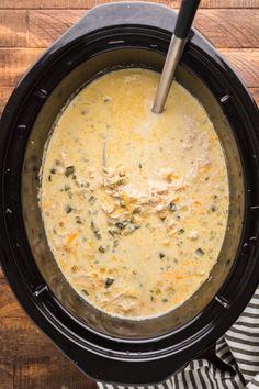 a pot filled with soup on top of a wooden table