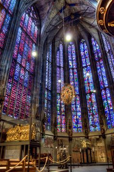 the inside of a cathedral with stained glass windows