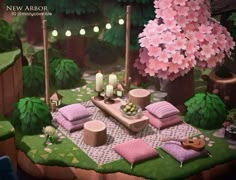 a table set up for a picnic in the middle of a forest with pink flowers