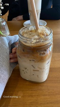 a jar filled with food sitting on top of a wooden table