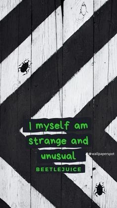 a sign that is on the side of a wooden fence saying i myself am strange and unusual