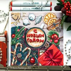 a christmas card with the words merry written in red and surrounded by other holiday items