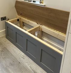 the inside of a room with wooden floors and gray painted walls, under construction work