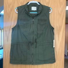 Grunge Green Zip Up Utility Vest Nwt In Great Condition Size Xxl Originally $30. Zipper Works Great And It Has 2 Working Pockets On The Chest As Well As 2 Big Pockets On The Belly. Has A Tightener String On The Waist. 28 Inches Long And 23 Inches From Pit To Pit. Affordable Brown Sleeveless Sweater Vest, Cheap Green Sleeveless Tank Top, Cheap Sleeveless Brown Vest, Cheap Brown Sleeveless Vest, Utility Vest, Big Pockets, Zip Ups, Jackets & Coats, Jackets For Women