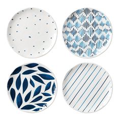 four plates with blue and white designs on them