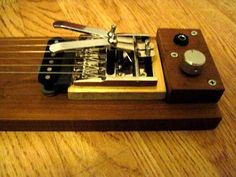 a miniature musical instrument on a wooden table