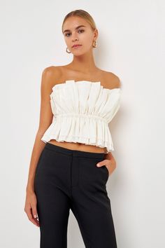 The Sheen Ruffled Strapless Top is a sophisticated versatile piece. Its strapless tube top style features accordion shirring at the neckline for subtle texture with elastic at the waist for a comfortable secure fit. A removable shoulder strap provides additional support and style options. Tube top Accordian shirring Elastic at waist Back zipper closure Removable shoulder strap Hand wash cold Do not bleach Do not tumble dry Iron low Shell: 78% Rayon 22% Nylon Lining: 92% Polyester 8% Spandex Excl Jumpsuit Fall, Knitwear Trends, Knit Loungewear, Strapless Bodycon Dress, Tweed Dress, Blazer And Shorts, Geek Chic, Leather Dresses, Heat Styling Products