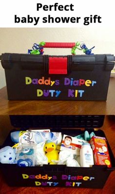 a black box filled with diapers and toys on top of a wooden table next to a