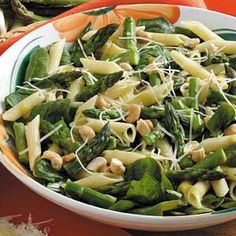 a white bowl filled with pasta and vegetables