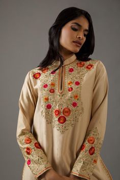 Beige straight kurta with rust orange floral pattern embroidery. Comes with churidar and crinkle dupatta.
Components: 3
Pattern: Hand Embroidered
Type Of Work: Floral
Neckline: Mandarin
Sleeve Type: Straight Long
Fabric: Chanderi Silk, Cotton, Lining: Cotton
Color: Beige
Other Details: 
Front potli buttoned collar
Attached lining
Occasion: Puja - Aza Fashions Orange Floral Embroidery Kurta For Eid, Traditional Orange Wear With Floral Embroidery, Orange Floral Embroidered Kurta For Eid, Orange Traditional Wear With Floral Embroidery, Eid Orange Kurta With Floral Embroidery, Traditional Orange Sets With Floral Embroidery, Straight Jamawar Kurta With Floral Embroidery, Festive Orange Kurta With Floral Embroidery, Long Beige Embroidered Kurta