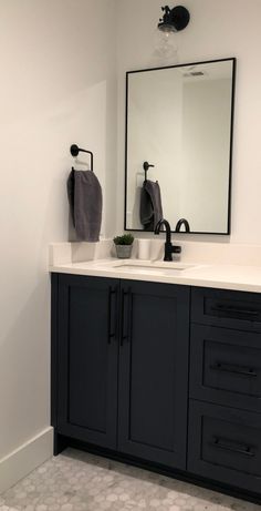 a bathroom vanity with two sinks and a large mirror