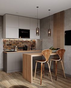 a kitchen with two chairs and a table in front of a tv on the wall