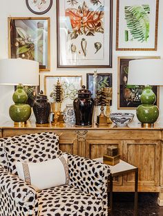 a living room filled with furniture and pictures on the wall