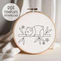 the embroidery pattern shows a sleeping bear on a branch