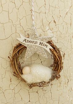 a star ornament hanging on the side of a wall with a bird nest