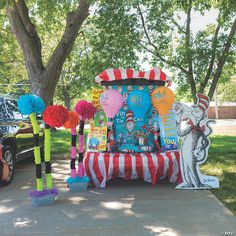 the dr seuss and cat in the hat display is decorated with balloons, pom - poms, and streamers