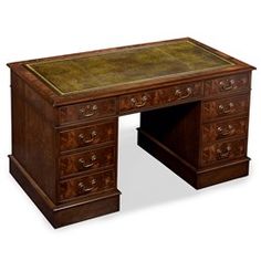 an old wooden desk with two drawers and a large leather top on the bottom shelf