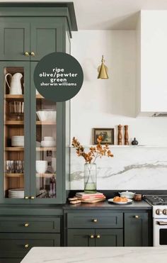 the kitchen is decorated in shades of green and white, with gold accents on the cabinets