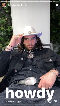 a man sitting in a chair wearing a cowboy hat with the words howdy on it