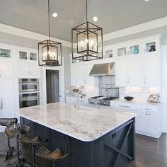 a large kitchen with an island in the middle