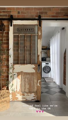 an old door is open in front of a brick wall and white tile flooring