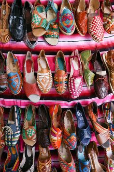 several rows of colorful shoes are on display