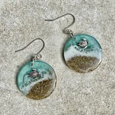 "These realistic beach earrings are made with layers of resin, bright colorful inks and real sand with a 3D silver turtle floating in the surf. These earrings are 1\" diameter. I make my own molds and each set is handmade so you won't find these anywhere else. Check out my other listing for the same style in a larger diameter. https://etsy.me/3s8D974 These are made to order and yours may be slightly different than those pictured." Resin Earrings For Summer Beach, Blue Resin Earrings For The Beach, Handmade Ocean-inspired Earrings For Beach Season, Sea Turtle Earrings, Cartiloge Earring Turtle, Tropical Jewelry, Turtle Beach, Beach Earrings, Turtle Earrings