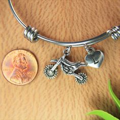 ♥ Dirt Bike Bracelet Motocross Rider Bangle Motocross Charm Dirt Bike Charm Bangle Motocross Jewelry Moto Mom Gift Personalized Bangle ♥ This is a silver-tone Dirt Bike charm with hand stamped initial charm on an expandable bangle. ♥ You will receive 1 bangle ♥ Motocross Charm 17x22 mm. ♥ Initial charm stainless steel 10mm choose from a drop-down menu. ♥ Bangle 57-64 mm ♥ additional initial https://www.etsy.com/listing/766732811 If you need help with your first purchase on Etsy, here is a helpfu Silver Biker Jewelry As A Gift, Silver Biker Bracelets For Gift, Silver Biker Style Bracelets As Gifts, Adjustable Silver Jewelry For Biker Events, Bike Bracelet, Moto Mom, Personalised Bangle, Pilot Gifts, Aunt Gifts