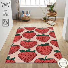 a rug with strawberries on it in the middle of a room next to a window