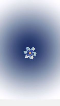 a blue and white flower floating in the air