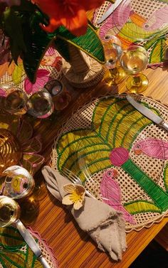 a wooden table topped with plates and silverware