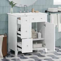 a white bathroom vanity with drawers under a mirror