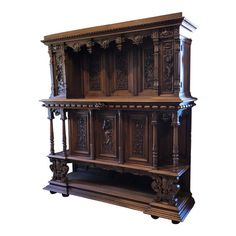 an old wooden cabinet with carvings on the front and sides, isolated against a white background