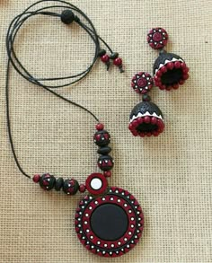 a red and black beaded necklace with matching earrings