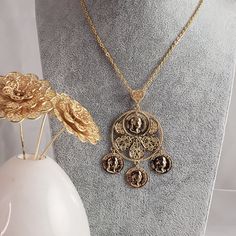 Unleash your inner goddess with our Roman Coin Filigree Pendant! This iconic piece features an ancient circle coin, symbolizing strength and power. Complete the boho chic look with the included 30" chain. Elevate your style and embrace the beauty of the past. Limited stock available! Gold Coin Pendant Necklace For Festival, Gold Bohemian Coin Pendant Necklace, Gold Bohemian Coin Necklace With Round Pendant, Bohemian Gold Coin Necklace With Round Pendant, Festival Coin Pendant Necklace In Medallion Shape, Festival Coin Pendant Medallion Necklace, Festival Medallion Necklace With Coin Pendant, Medallion Necklace With Coin Pendant For Festivals, Bohemian Brass Medallion Necklace With Coin Pendant