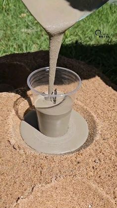 the sand is being poured into a cup