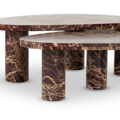 two tables made out of marble with one table sitting on top of the other, both in different shapes and sizes