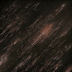 an image of rain falling down on the ground in the night sky with stars and lines