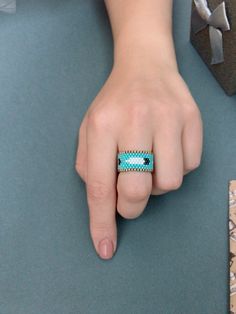 a person's hand with a ring on it