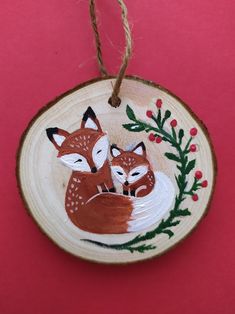 a wooden ornament with two foxes on it