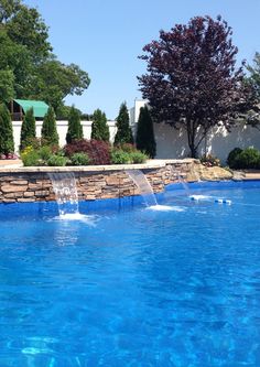 a pool with blue water and trees in the background