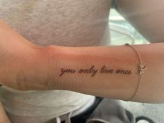 a woman's arm with the words you only live once tattooed on her wrist