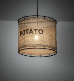 a lamp shade that says potato hanging from the ceiling