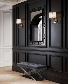 a black cabinet with a mirror and bench in front of it